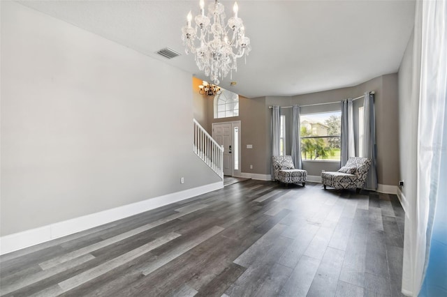 interior space featuring an inviting chandelier and dark hardwood / wood-style floors