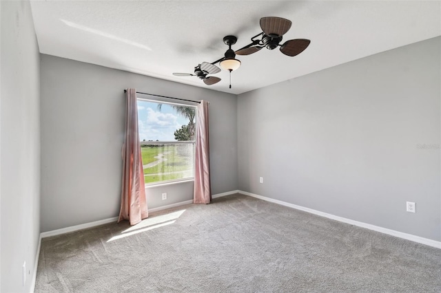 carpeted spare room with ceiling fan