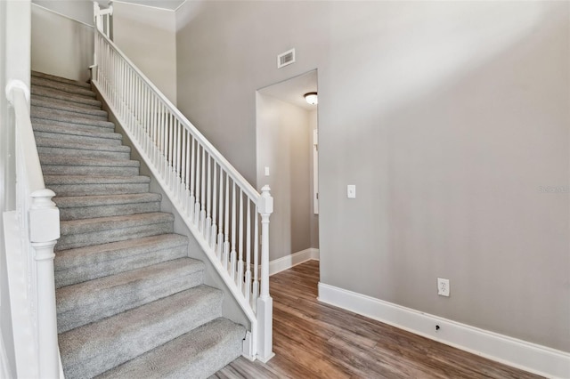 stairs featuring dark hardwood / wood-style floors