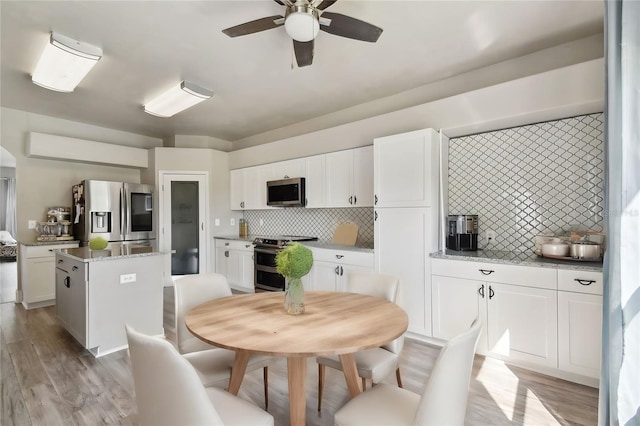 dining area featuring light hardwood / wood-style flooring and ceiling fan