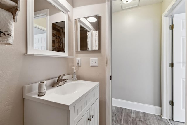 bathroom featuring oversized vanity and hardwood / wood-style flooring