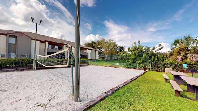 exterior space with a lawn and volleyball court