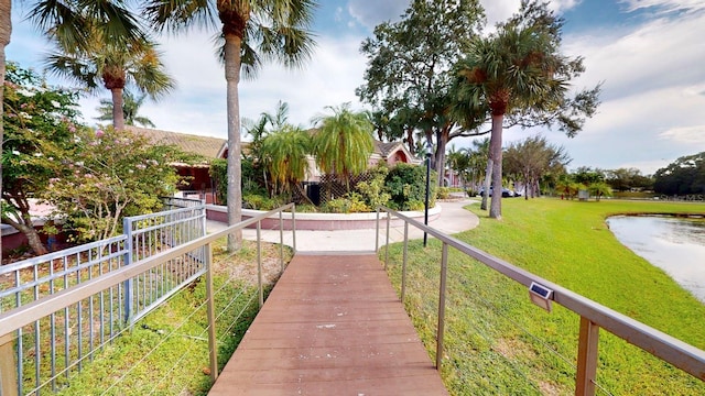 surrounding community featuring a yard and a water view