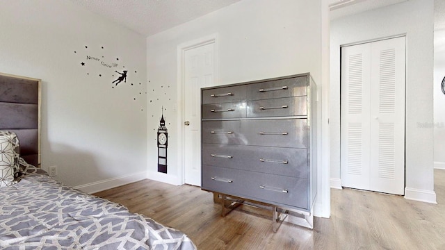 bedroom with a closet and light wood-type flooring