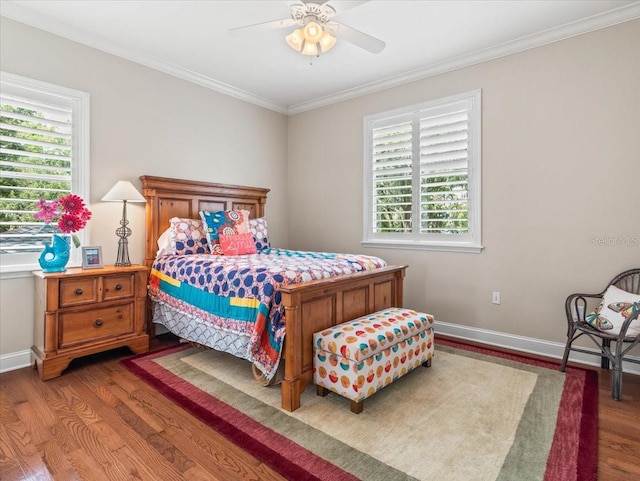 bedroom with ceiling fan, ornamental molding, multiple windows, and wood-type flooring