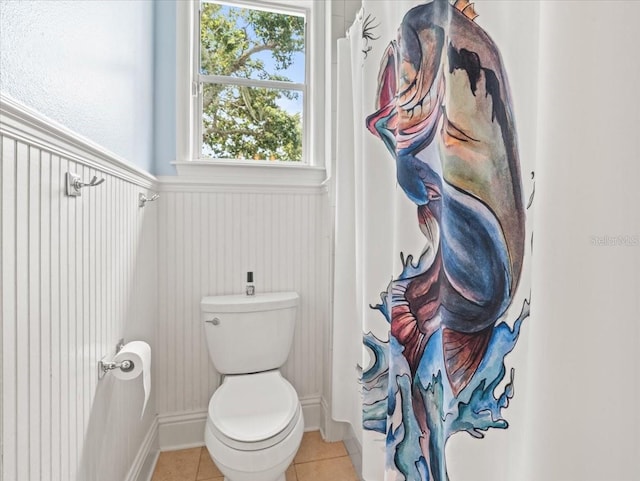 bathroom with tile flooring and toilet