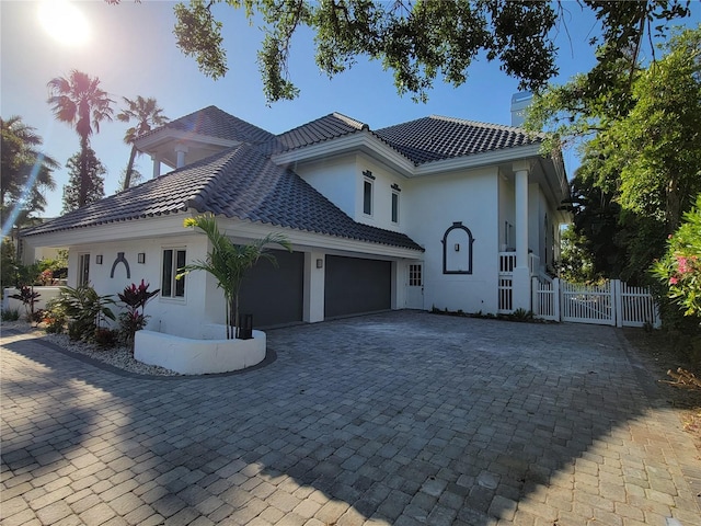 mediterranean / spanish home featuring a garage