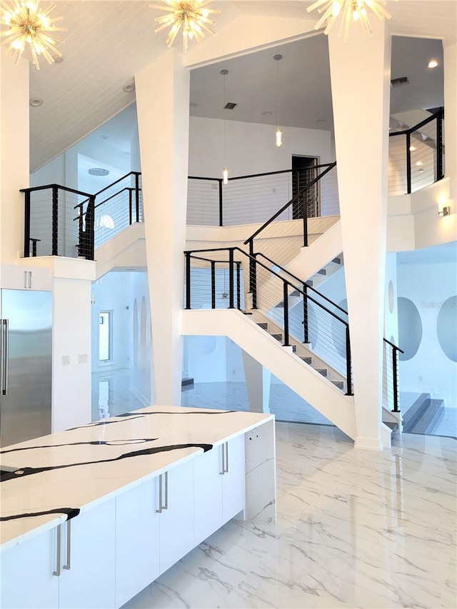 interior space featuring an inviting chandelier and a high ceiling