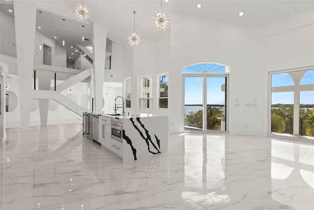 living room with high vaulted ceiling, sink, and a wealth of natural light