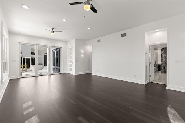 unfurnished living room featuring ceiling fan and dark hardwood / wood-style floors