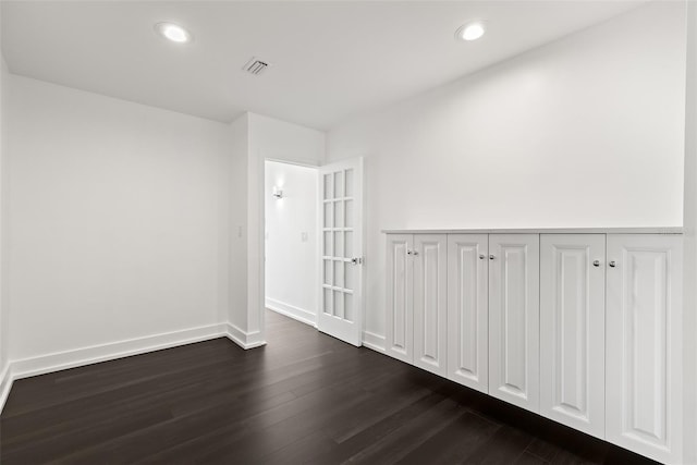 spare room featuring dark wood-type flooring