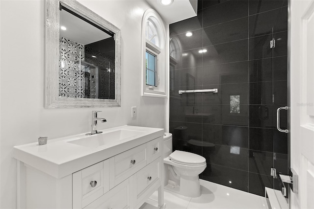 bathroom with vanity, toilet, and an enclosed shower