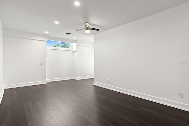 spare room featuring dark wood-type flooring and ceiling fan