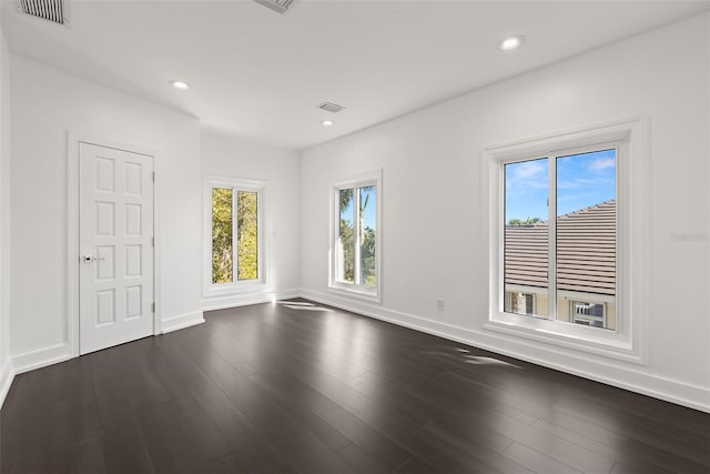 unfurnished room with dark hardwood / wood-style floors