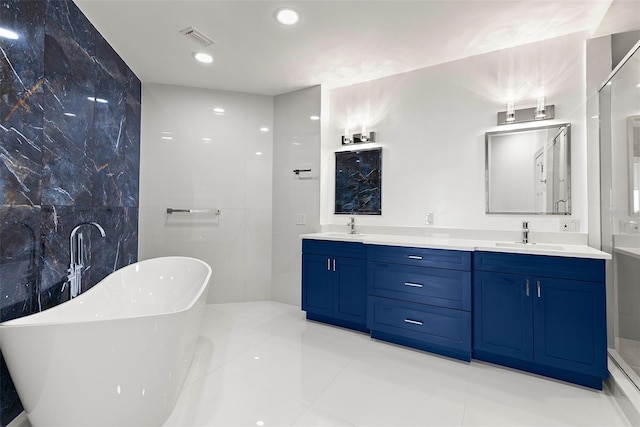 bathroom with tile patterned flooring, vanity, and a bathing tub