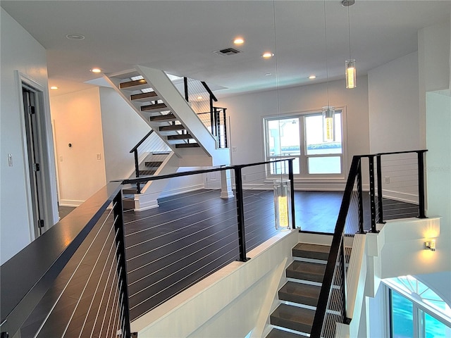 staircase with hardwood / wood-style flooring