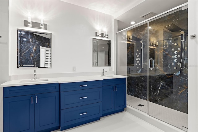 bathroom with a shower with door and vanity