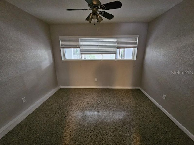 spare room with plenty of natural light, a textured ceiling, and ceiling fan