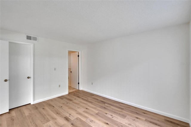 spare room with light hardwood / wood-style flooring