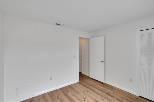 empty room with light hardwood / wood-style flooring