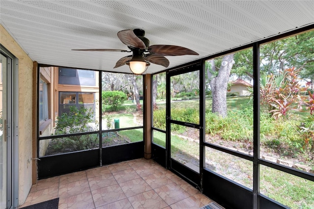 unfurnished sunroom featuring plenty of natural light and ceiling fan