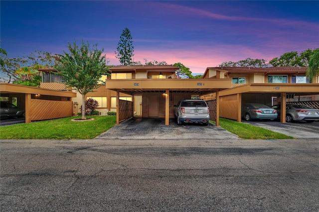 view of front of home with a lawn and a carport