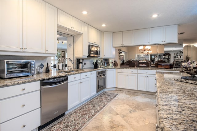 kitchen with stainless steel appliances, sink, white cabinetry, and light tile floors