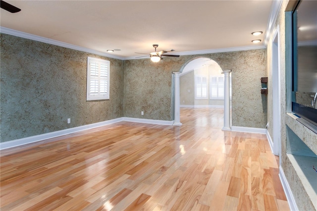 unfurnished room featuring ornamental molding, plenty of natural light, ceiling fan, and light hardwood / wood-style flooring