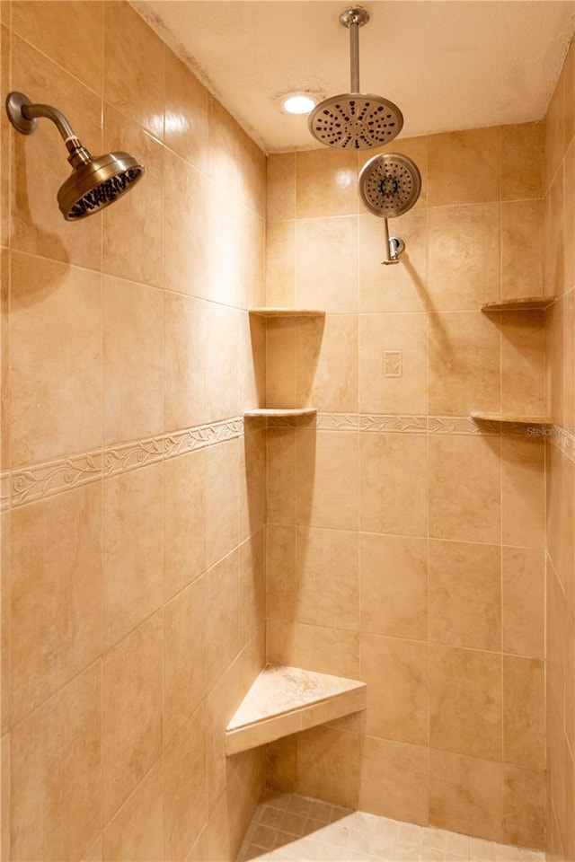 bathroom with tiled shower