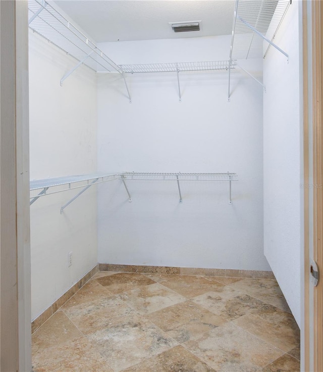 spacious closet featuring tile flooring