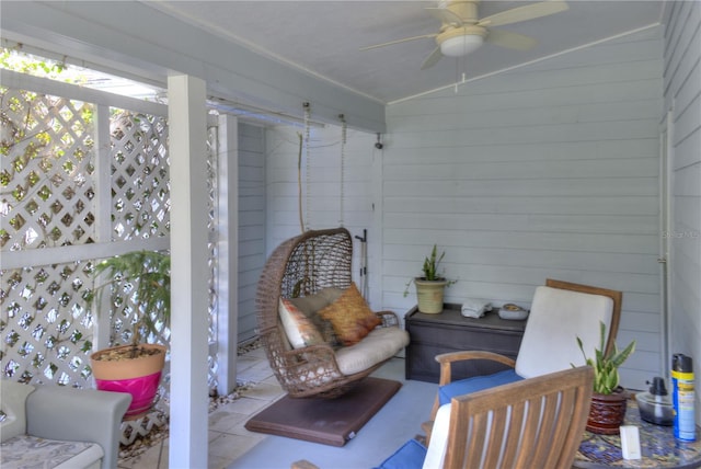 sunroom featuring ceiling fan and vaulted ceiling