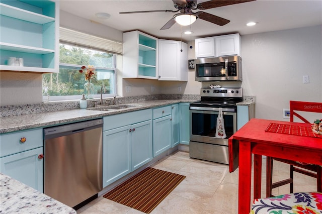 kitchen with sink, light tile flooring, ceiling fan, and stainless steel appliances