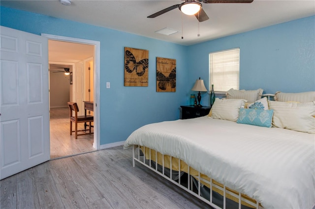 bedroom with ceiling fan and hardwood / wood-style floors