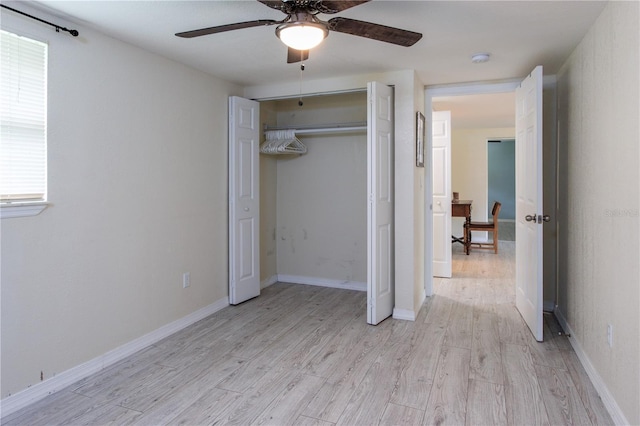 unfurnished bedroom featuring multiple windows, a closet, ceiling fan, and light hardwood / wood-style flooring