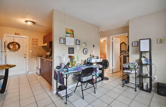 dining area with light tile patterned floors and a textured ceiling