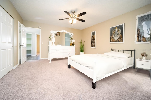 carpeted bedroom with a closet and ceiling fan