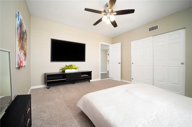 bedroom with a closet, ceiling fan, and light colored carpet