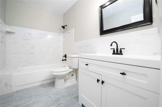 full bathroom featuring vanity, tile walls, tile floors, tiled shower / bath, and toilet