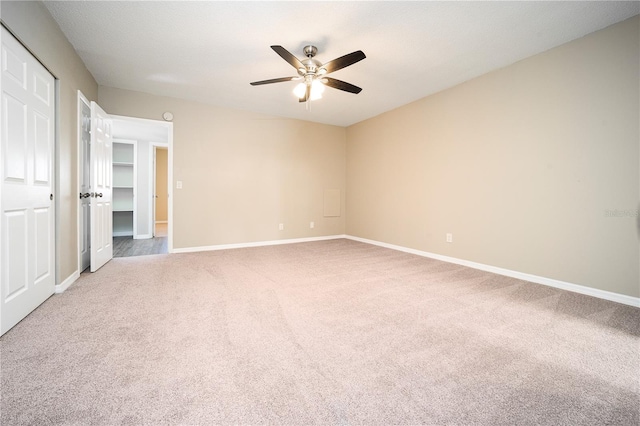 unfurnished bedroom with light carpet, a closet, and ceiling fan