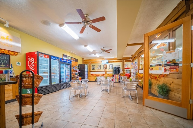 interior space featuring light tile flooring, ceiling fan, and a textured ceiling