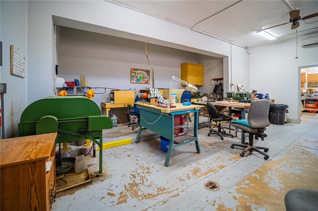 office space featuring a wall mounted air conditioner, ceiling fan, and a workshop area