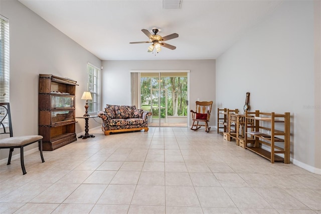 living area with light tile patterned flooring and ceiling fan