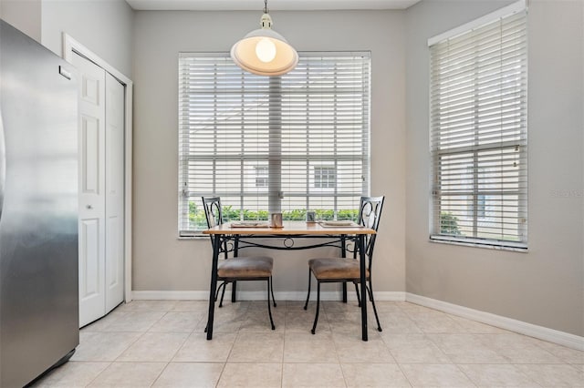 tiled dining space featuring a wealth of natural light