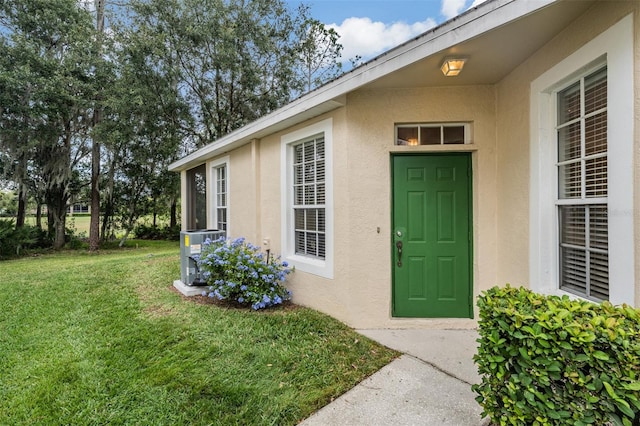 doorway to property with a lawn