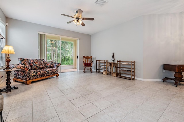 living area with light tile patterned flooring and ceiling fan