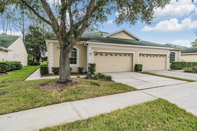 ranch-style house featuring a front lawn and a garage