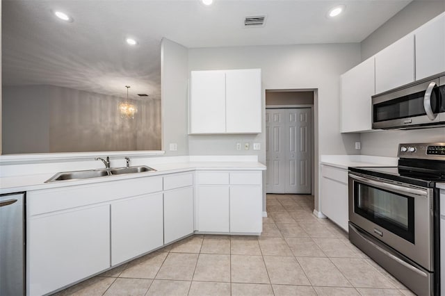 kitchen with white cabinets, stainless steel appliances, sink, and decorative light fixtures