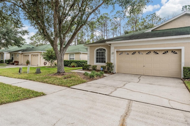 ranch-style house featuring a garage and a front lawn