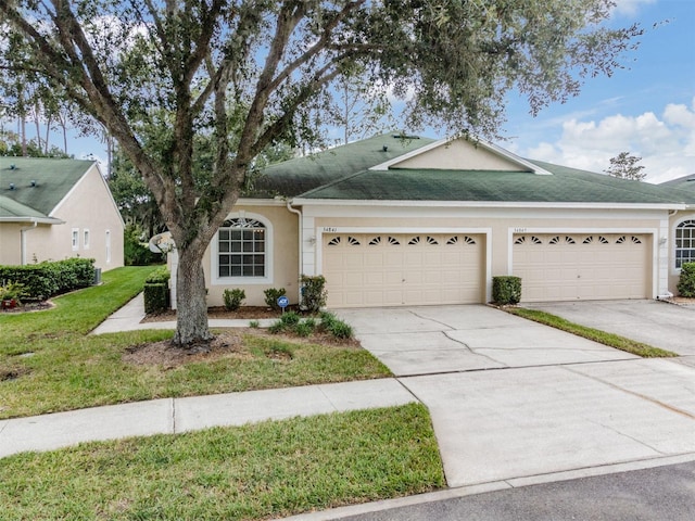 ranch-style house with a garage and a front yard