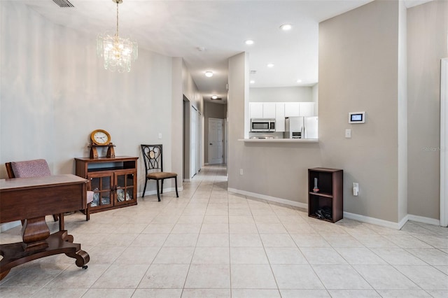 interior space with light tile patterned flooring and an inviting chandelier